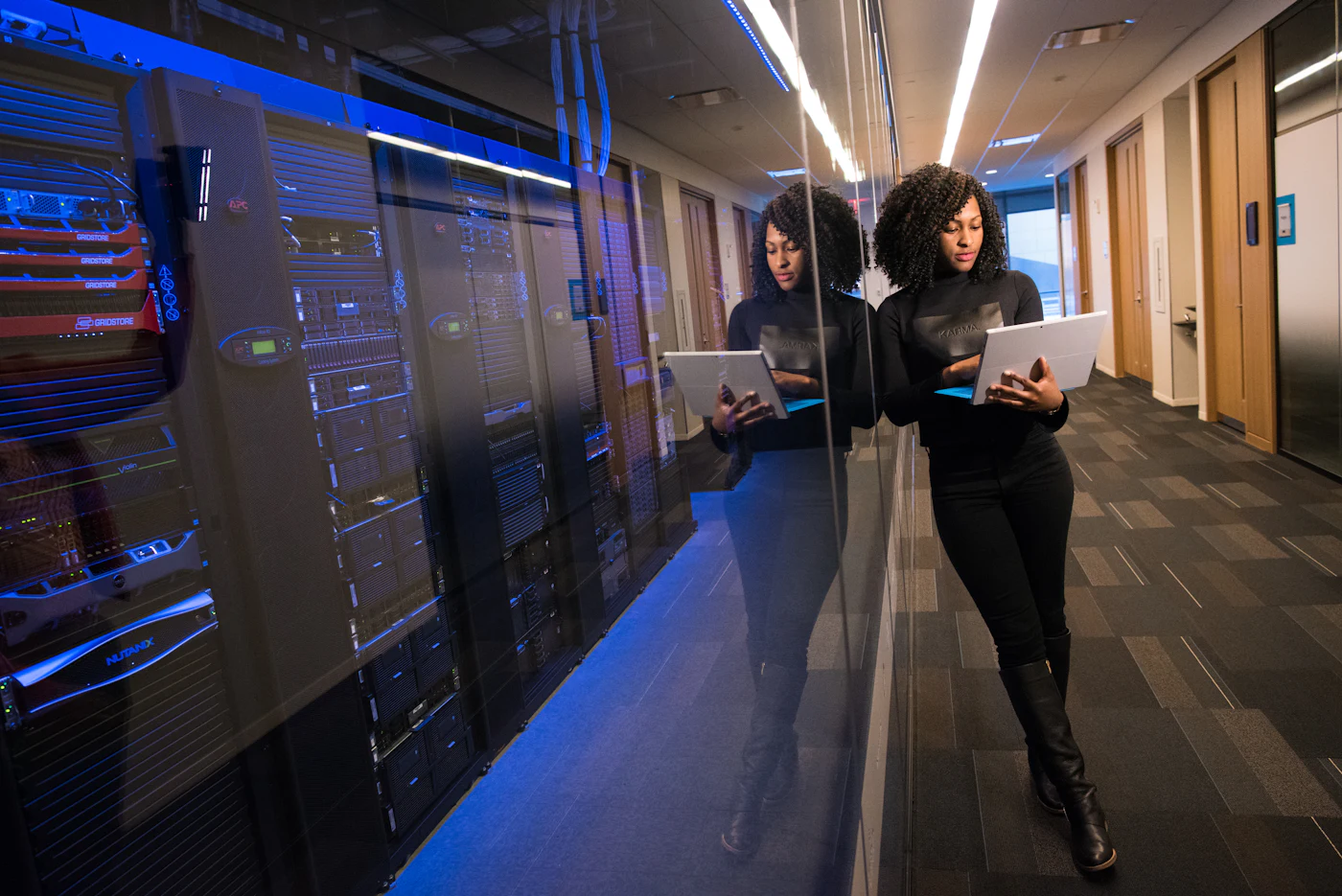TechnData team member reviewing systems in a modern server room